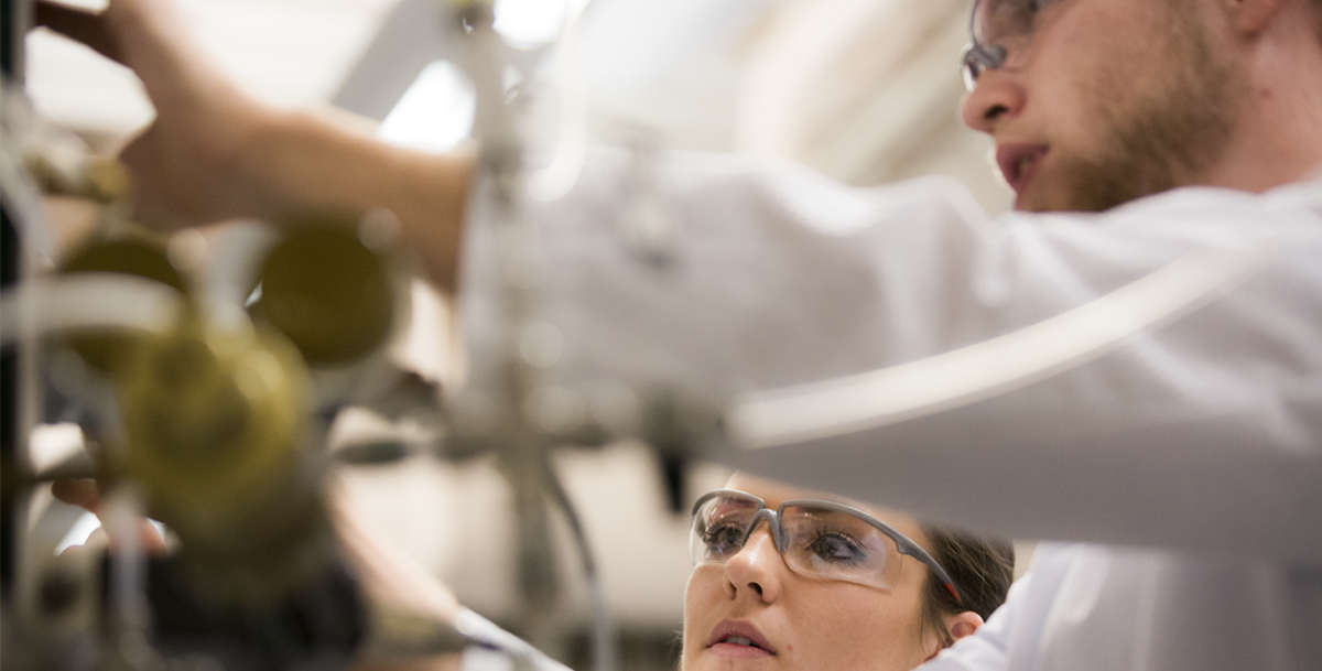 photo: two students working together in a lab