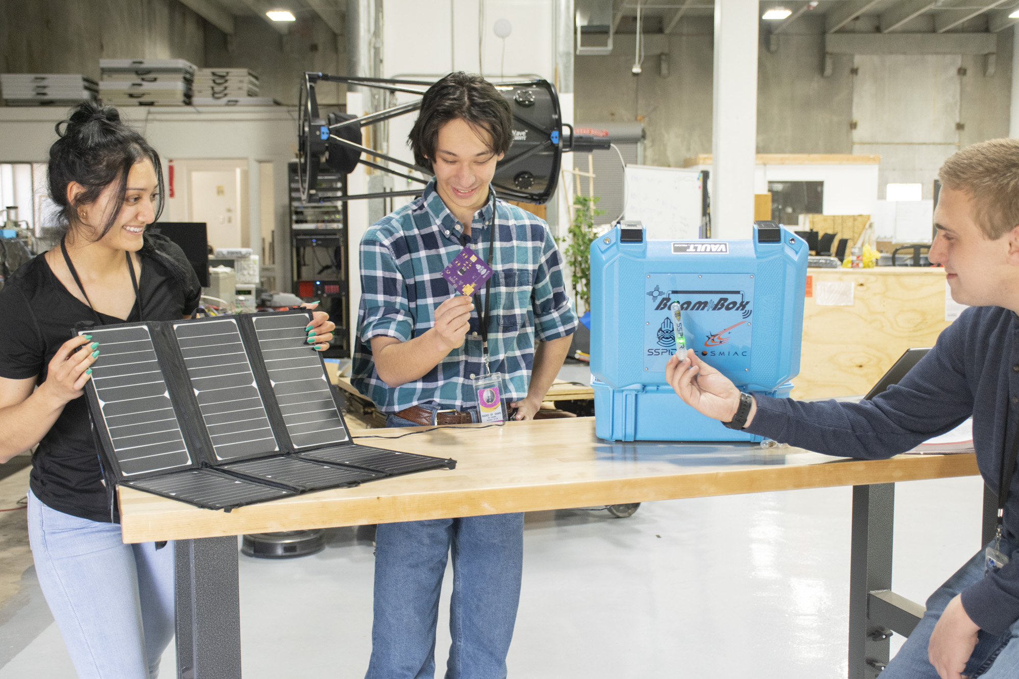 photo: Leilani Baker, Dante Orona Yang and Will Hamel demonstrate the outreach tools used by COSMIAC.