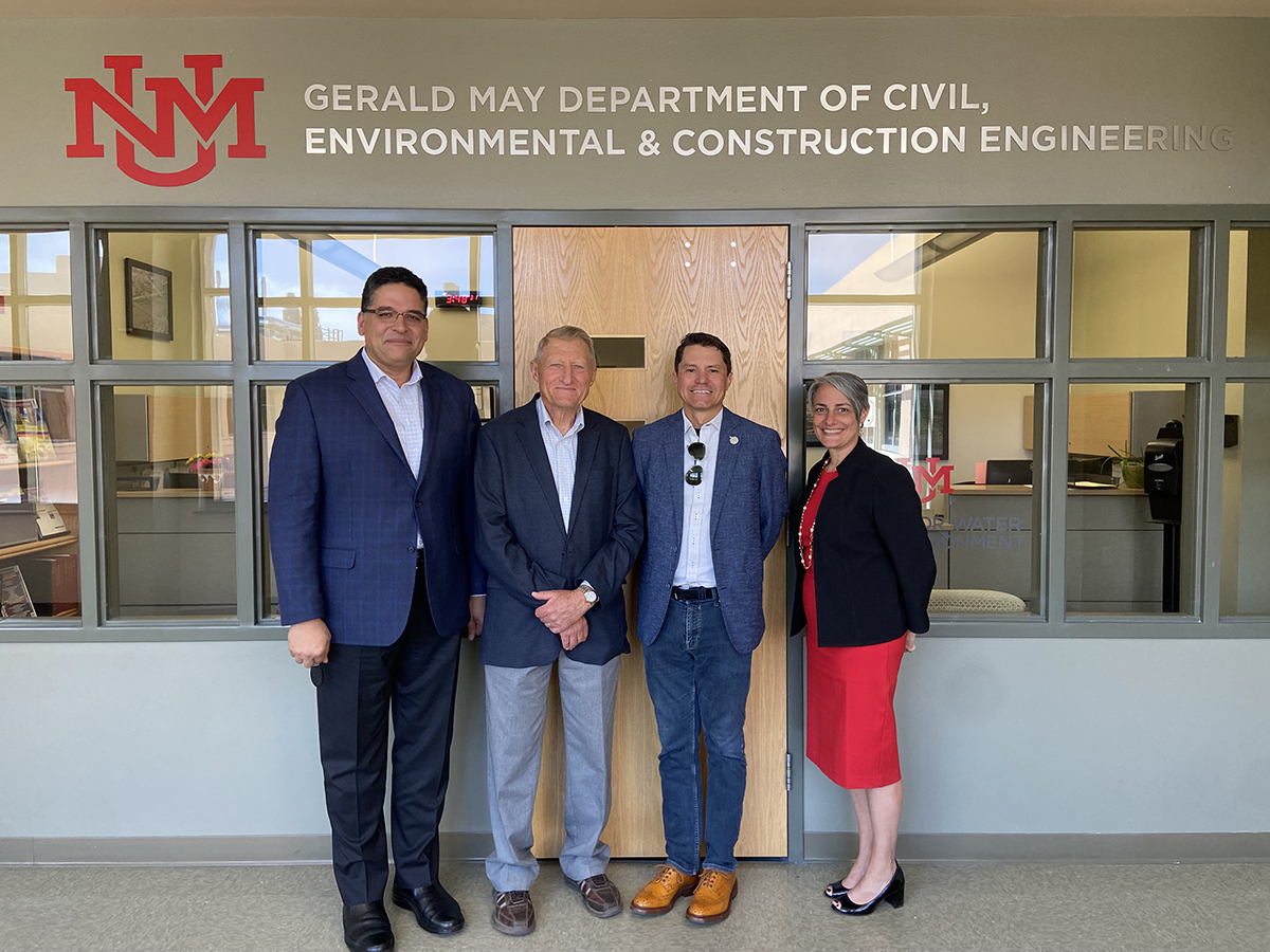 photo: Mahmoud Taha, Gerald May, Doug Campbell and Donna Riley stand underneath the new department sign.